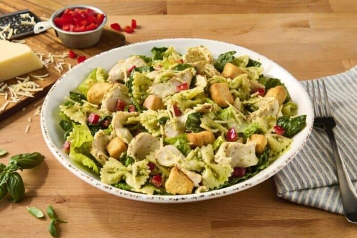 Beloved eatery makes Pesto Pasta Chicken Caesar Salad a permanent menu item and highlights seasonal offerings