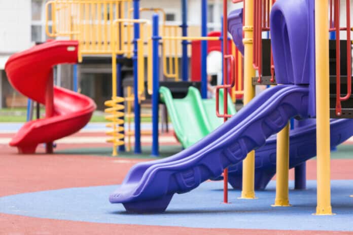 Children's colored slides playground on a street. Planning a Commercial Playground Project